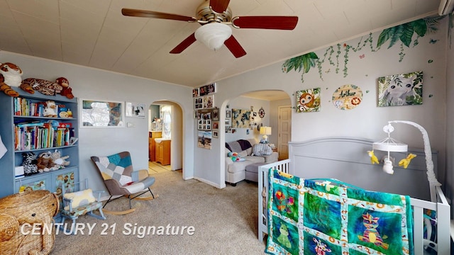 bedroom with crown molding, a ceiling fan, arched walkways, and carpet floors