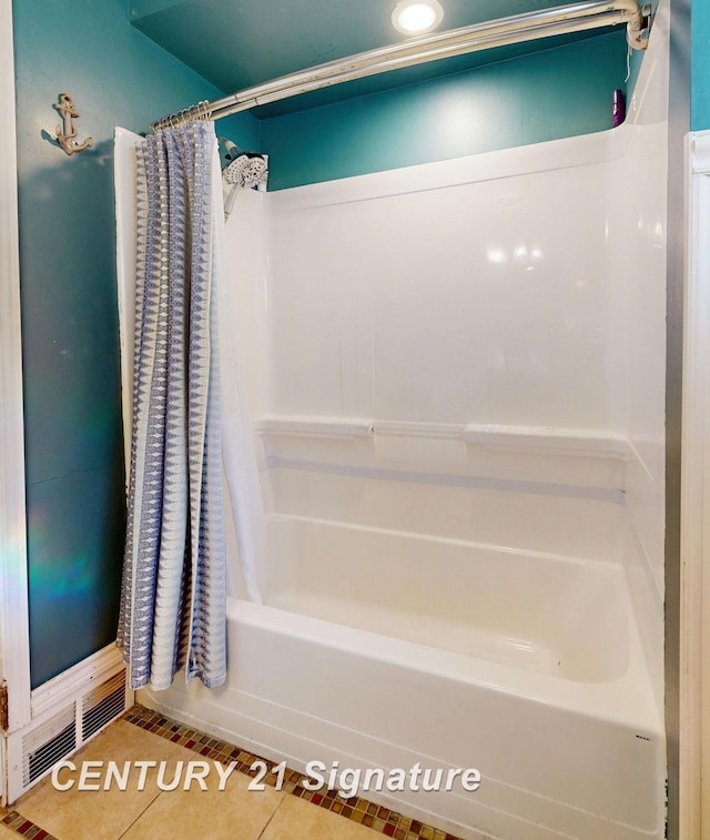 full bathroom featuring tile patterned floors, visible vents, and shower / tub combo with curtain