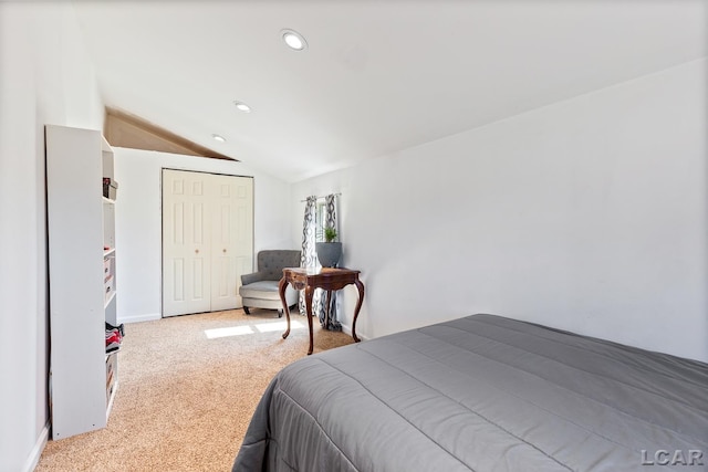 bedroom featuring lofted ceiling, recessed lighting, carpet, and a closet