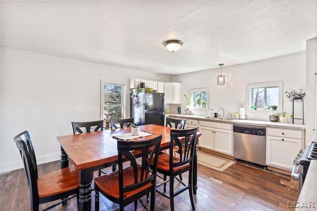 dining area featuring baseboards and dark wood finished floors