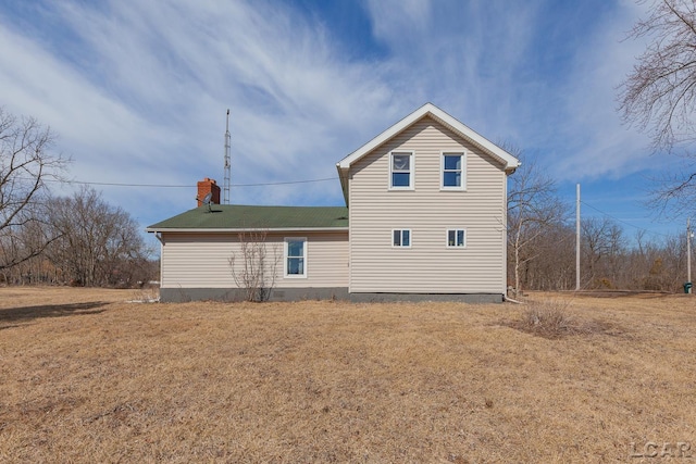 rear view of house with a yard