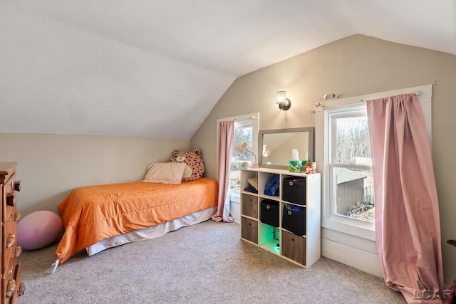 carpeted bedroom featuring multiple windows and vaulted ceiling