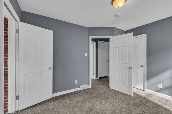 unfurnished bedroom with a closet, baseboards, and carpet flooring