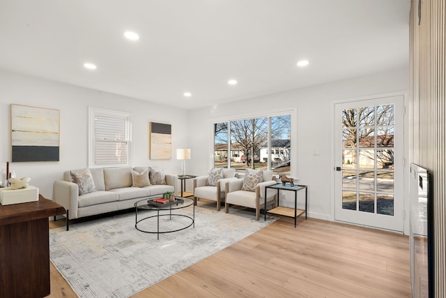 living area with recessed lighting and light wood-type flooring