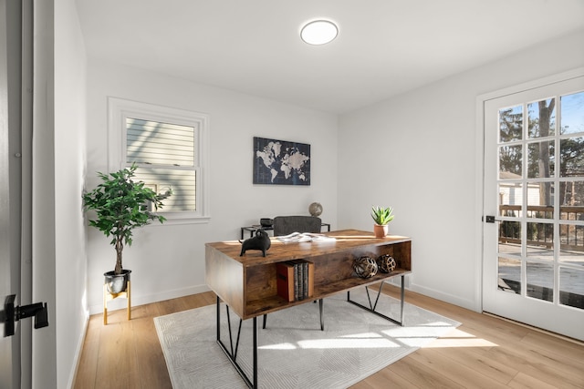 office area with light wood-style flooring and baseboards