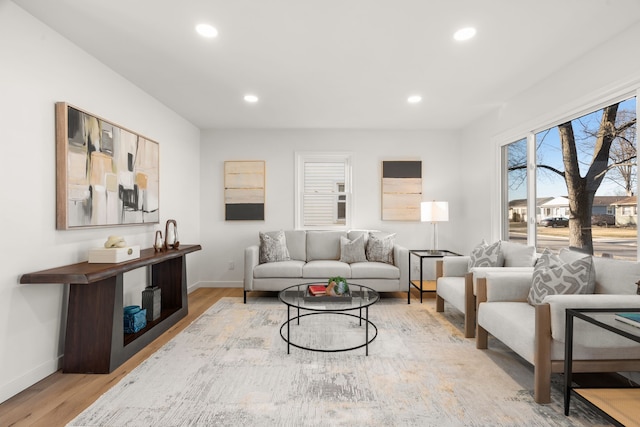 living area with recessed lighting, baseboards, and light wood-style floors