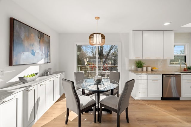 dining space featuring plenty of natural light, recessed lighting, and light wood-type flooring