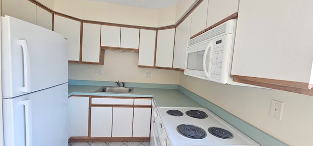 kitchen with light countertops, light tile patterned flooring, white appliances, white cabinetry, and a sink