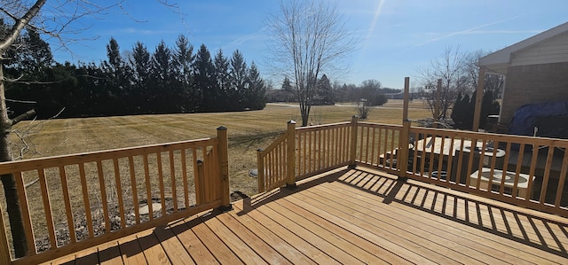 wooden deck featuring a lawn