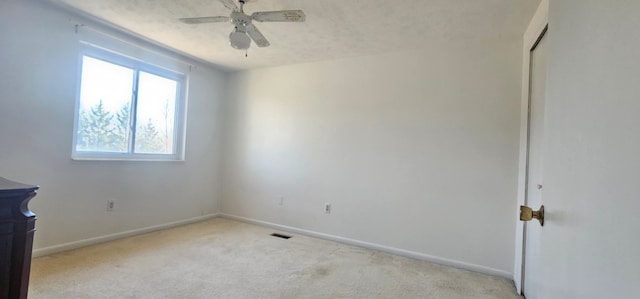 unfurnished bedroom with carpet, visible vents, baseboards, ceiling fan, and a textured ceiling