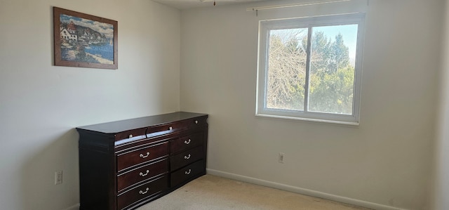 bedroom featuring baseboards and light colored carpet