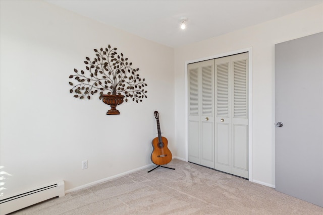 unfurnished bedroom featuring a closet, baseboard heating, light colored carpet, and baseboards