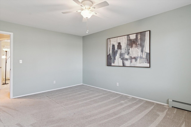 carpeted empty room featuring a ceiling fan, baseboards, and a baseboard radiator