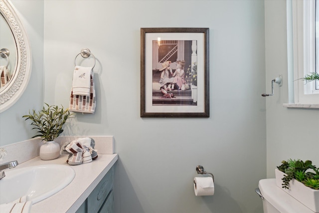 half bath featuring toilet and vanity