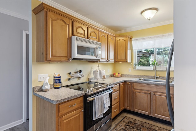 kitchen with electric range, ornamental molding, a sink, brown cabinetry, and white microwave