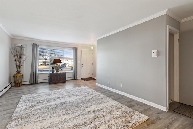 interior space with baseboards, wood finished floors, ornamental molding, and a baseboard radiator