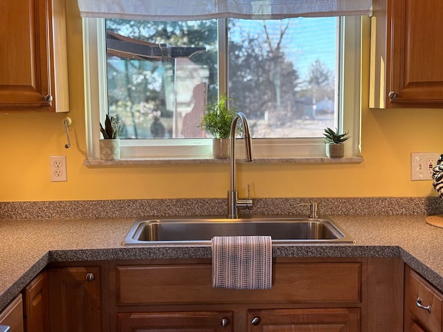 kitchen with a sink and brown cabinetry