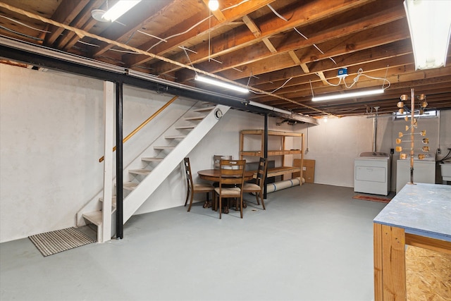 unfinished basement with washer and clothes dryer and stairs