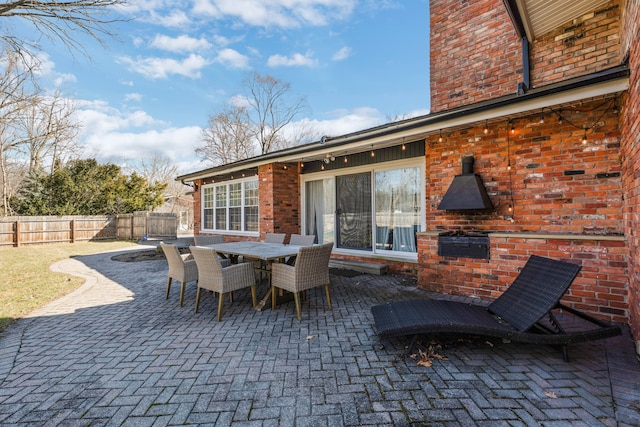 view of patio / terrace with outdoor dining space and fence