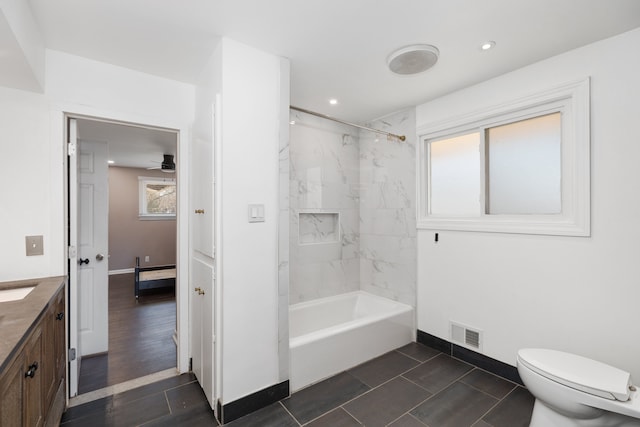 full bath featuring vanity, baseboards, visible vents, toilet, and shower / bathtub combination