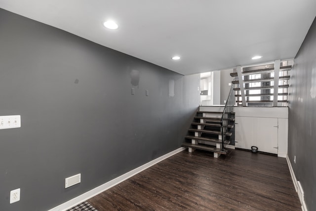 staircase with visible vents, recessed lighting, wood finished floors, and baseboards