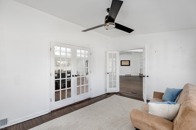 sitting room with wood finished floors, french doors, visible vents, and baseboards