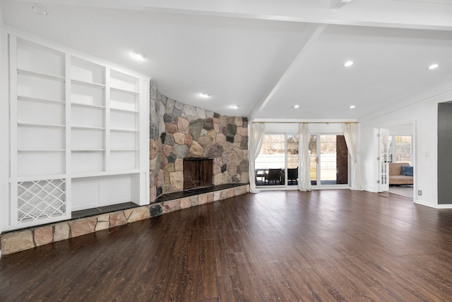 unfurnished living room featuring vaulted ceiling with beams, baseboards, recessed lighting, a fireplace, and wood finished floors