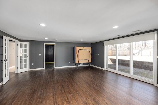 empty room featuring visible vents, baseboards, recessed lighting, french doors, and dark wood-style floors