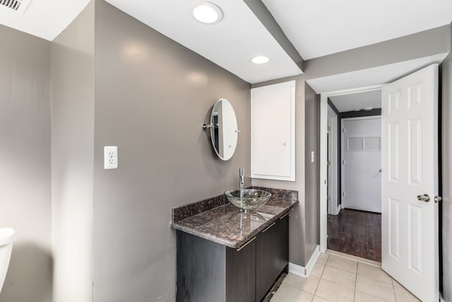 bathroom featuring vanity, visible vents, baseboards, recessed lighting, and tile patterned floors