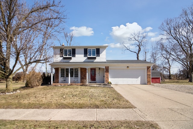 traditional home with brick siding, a front lawn, a chimney, a garage, and driveway