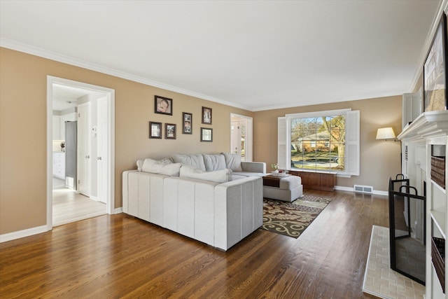 living room featuring crown molding, a fireplace, dark wood-style flooring, and baseboards