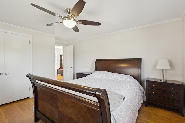 bedroom with crown molding, ceiling fan, and wood finished floors