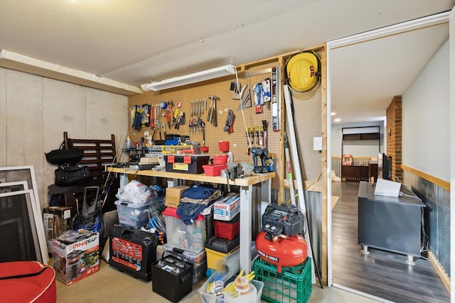 basement featuring a workshop area and wood finished floors