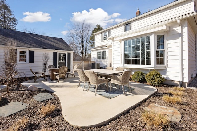 view of patio with outdoor dining space and fence