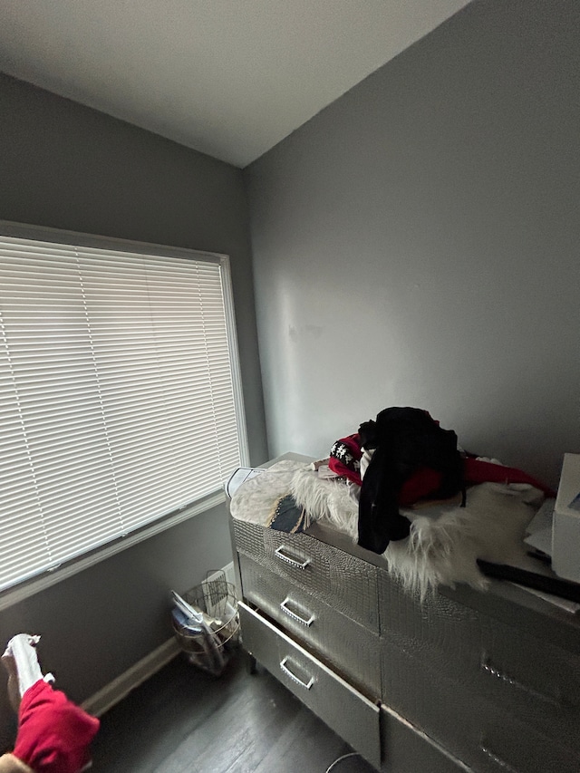 bedroom with baseboards and wood finished floors