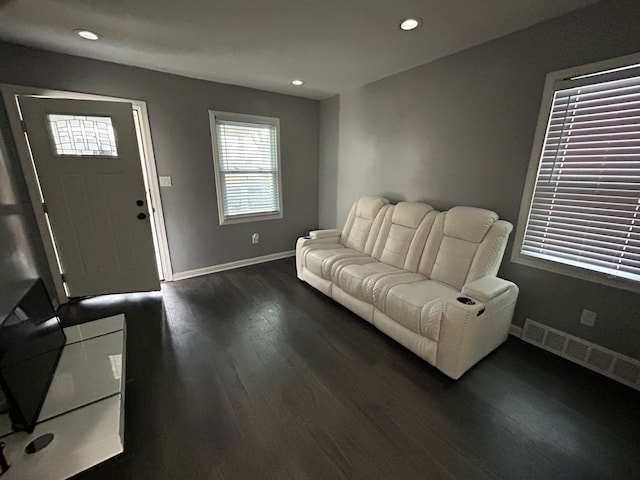 living room featuring recessed lighting, visible vents, baseboards, and dark wood-type flooring