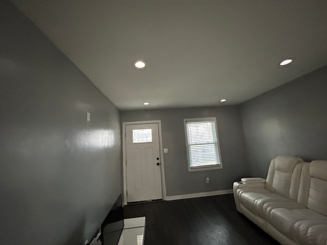 living room featuring recessed lighting, baseboards, and dark wood-style flooring