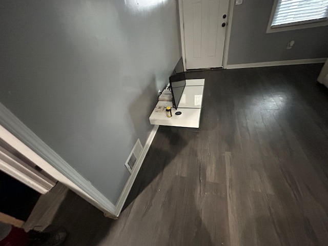 entrance foyer featuring visible vents, wood finished floors, and baseboards