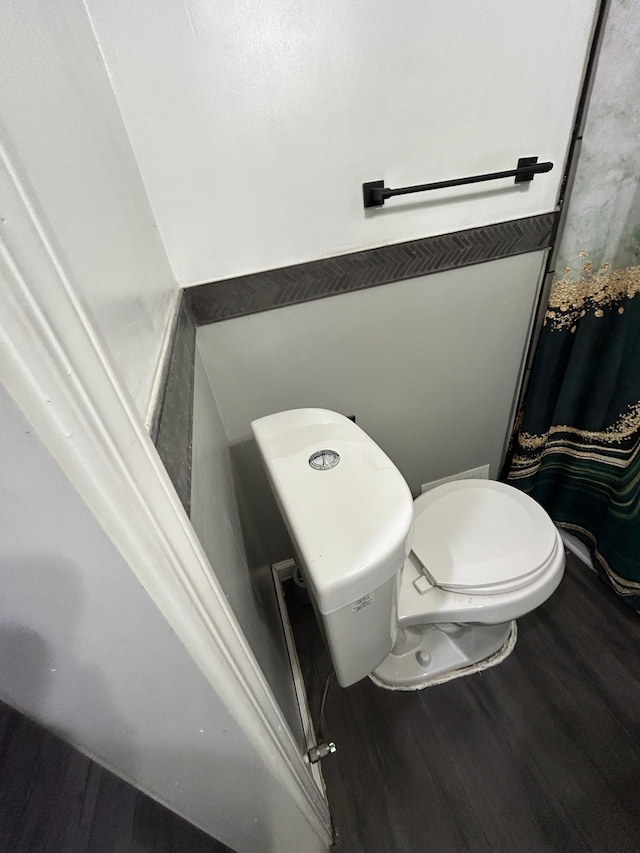 bathroom featuring toilet and wood finished floors