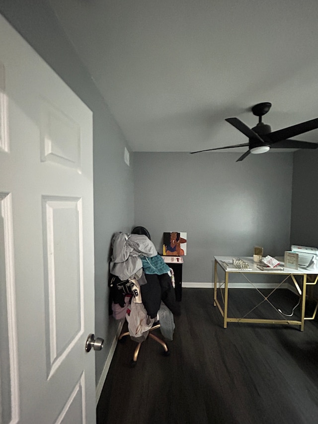 office area with a ceiling fan, baseboards, and dark wood-style flooring