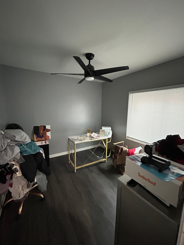 bedroom with dark wood-type flooring, a ceiling fan, and baseboards