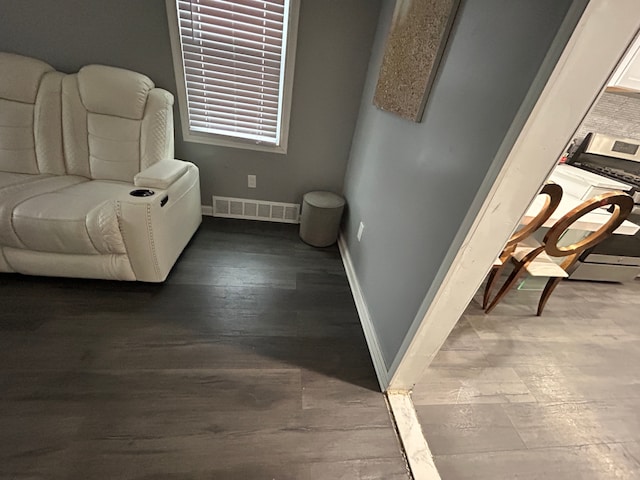 sitting room with visible vents, washer / dryer, baseboards, and wood finished floors