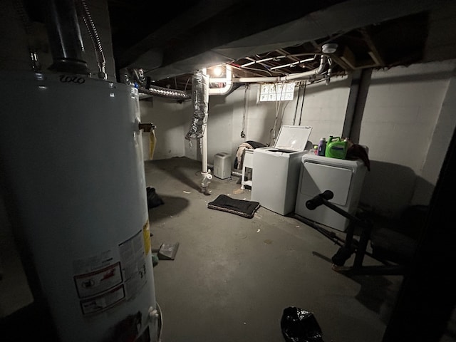 basement featuring independent washer and dryer and water heater