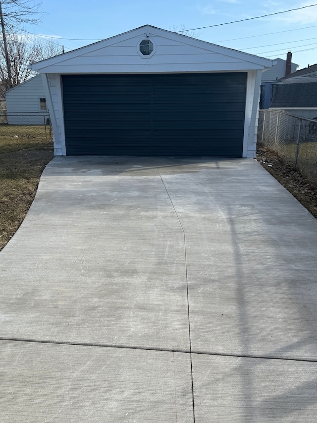 detached garage featuring fence