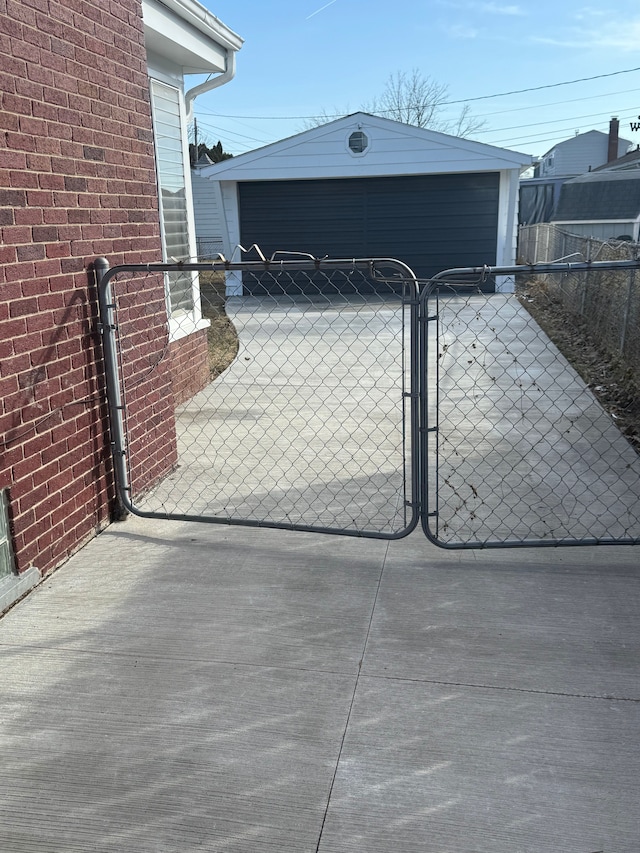 view of gate featuring an outbuilding and fence