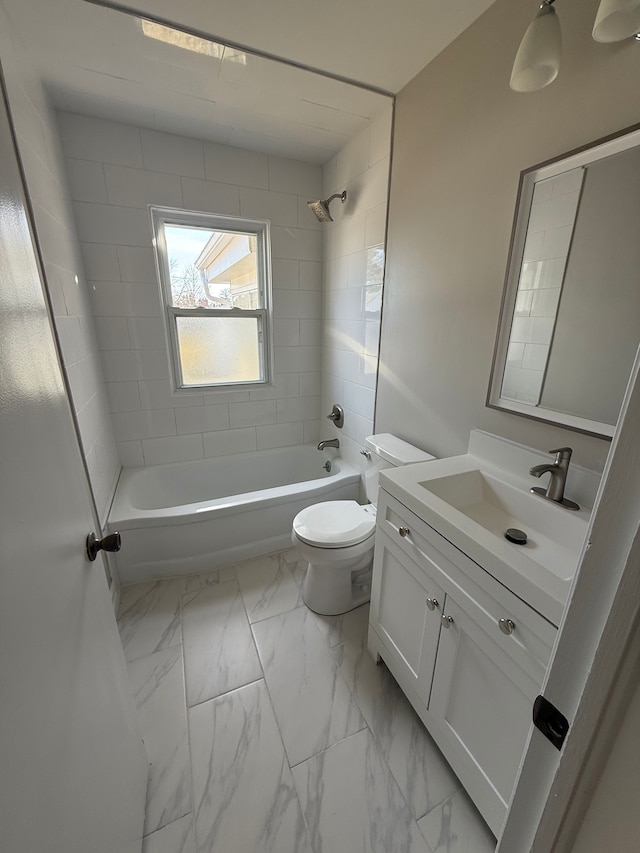 bathroom featuring toilet, marble finish floor, shower / washtub combination, and vanity