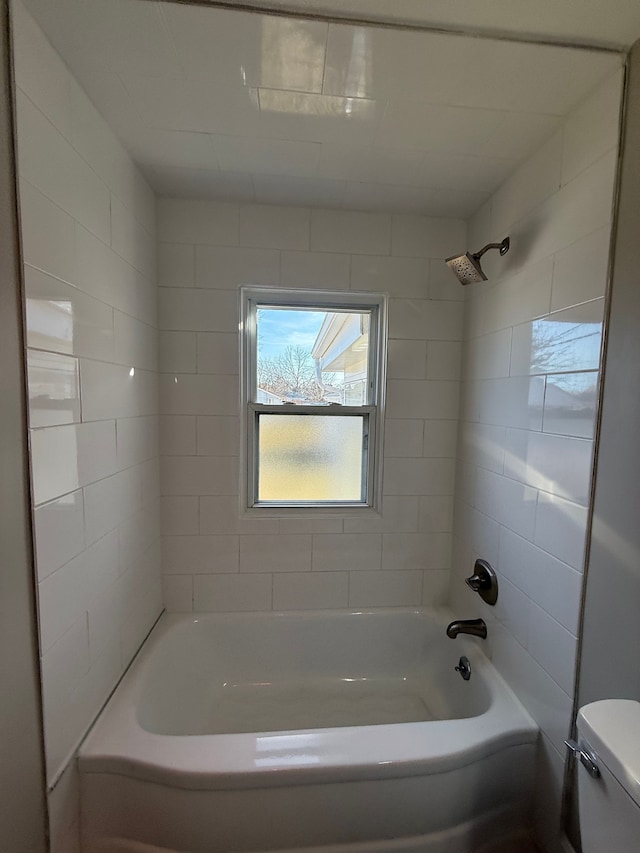 bathroom featuring bathing tub / shower combination and toilet