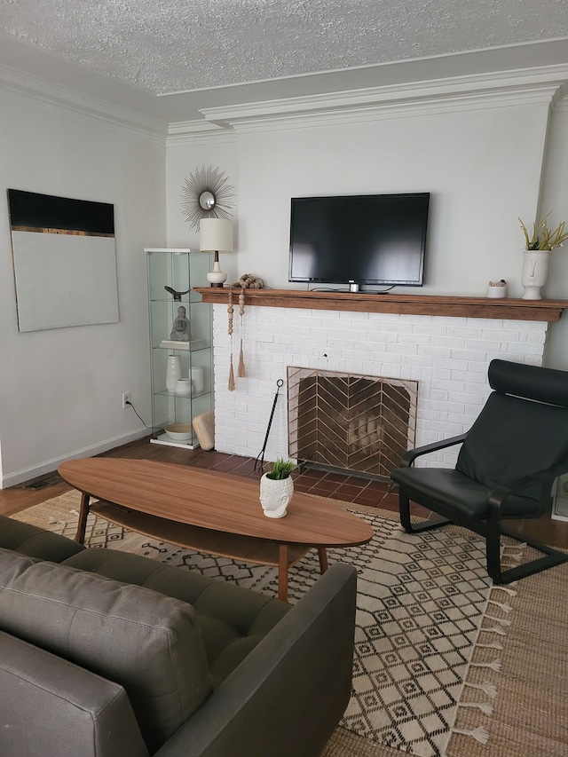 living area featuring a brick fireplace, crown molding, baseboards, wood finished floors, and a textured ceiling