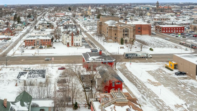 snowy aerial view with a residential view