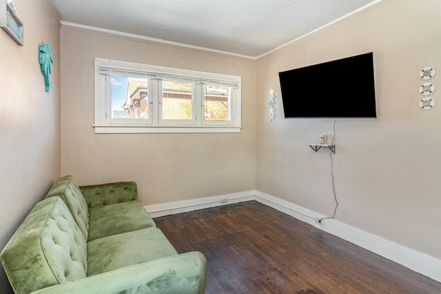 living area with baseboards, dark wood-style flooring, and ornamental molding